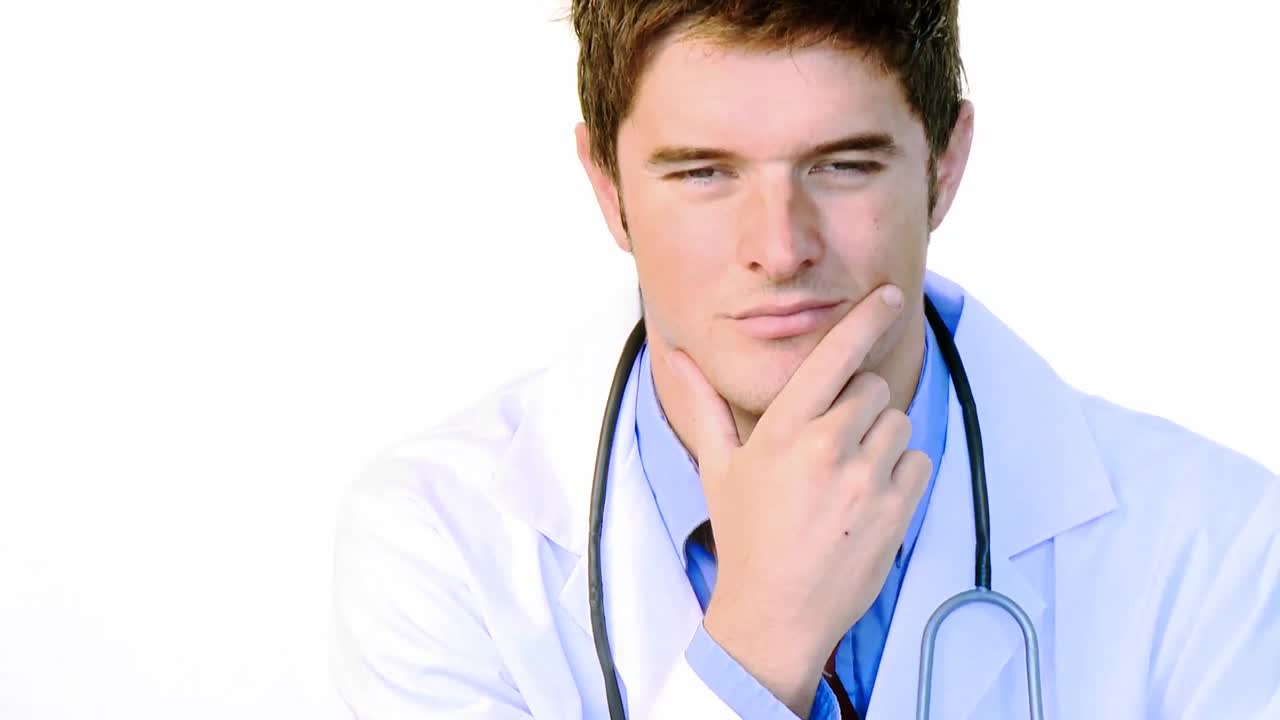 Handsome doctor looking at the camera footage