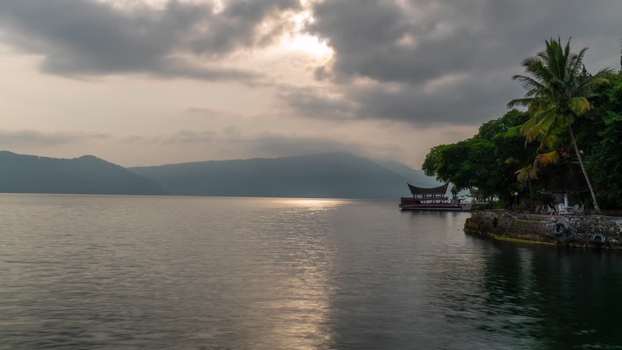 Serene Lake Landscape with Distant Mountains and Lakeside Pavilion