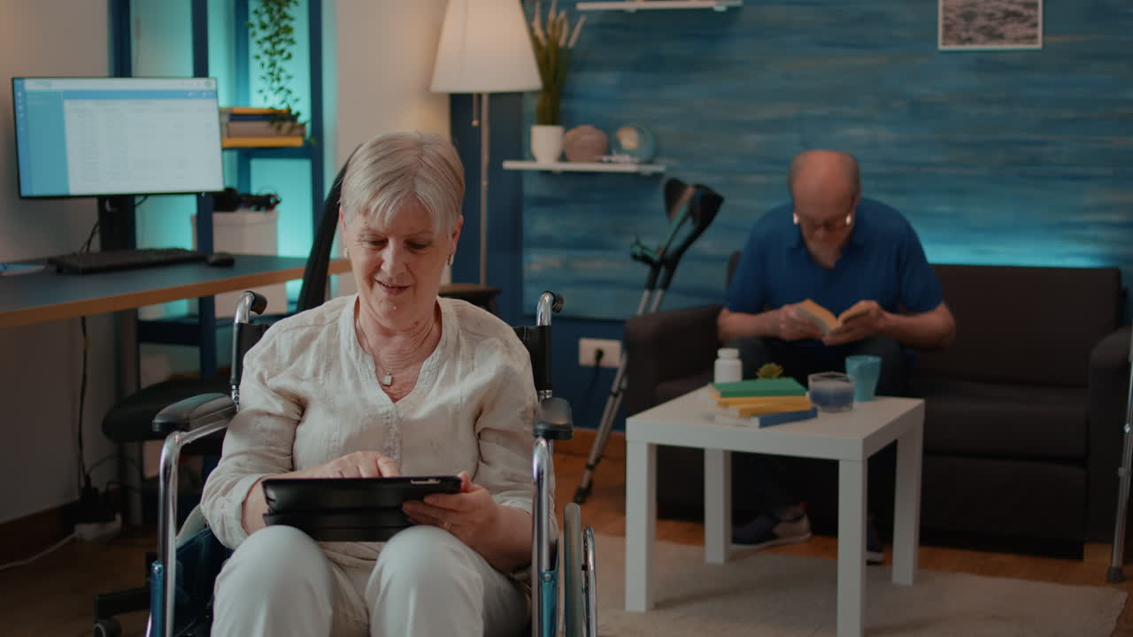 Elderly Woman Using Tablet in Wheelchair
