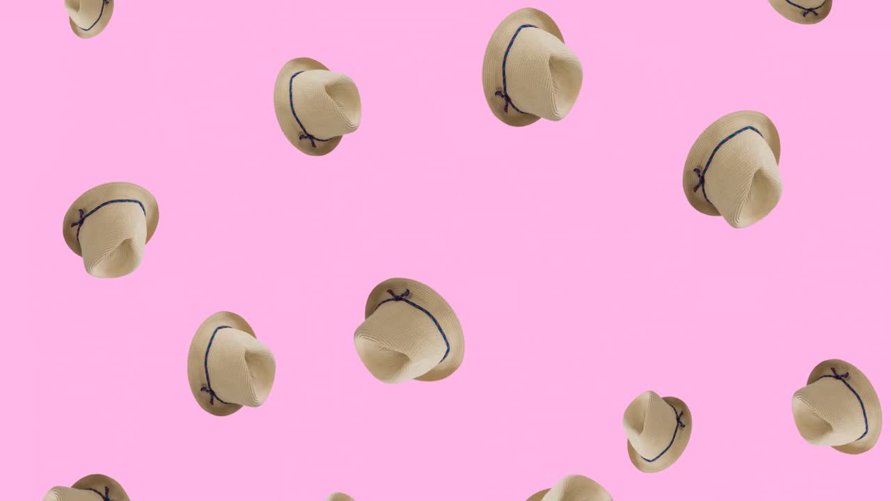 animación de sombreros con cinta cayendo sobre un fondo rosa