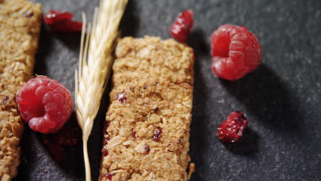 granola bars with barley and raspberry on concrete background 4k