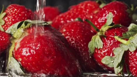 water splashing onto red strawberries