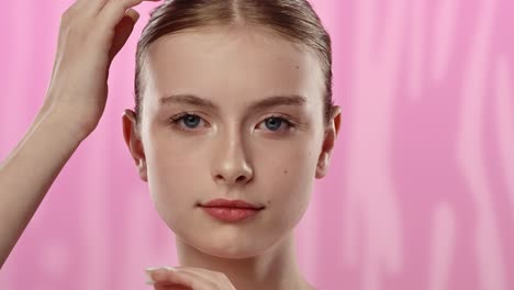 young woman with clear radiant face smiling gently for skincare a young woman with a clear complexion gently touches her face suggesting a skincare theme and youthful radiance