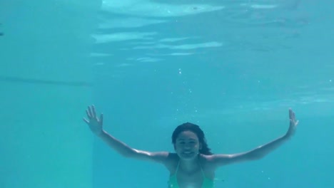 Pretty-woman-swimming-underwater-in-pool