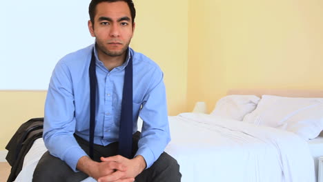 unhappy businessman sat on bed