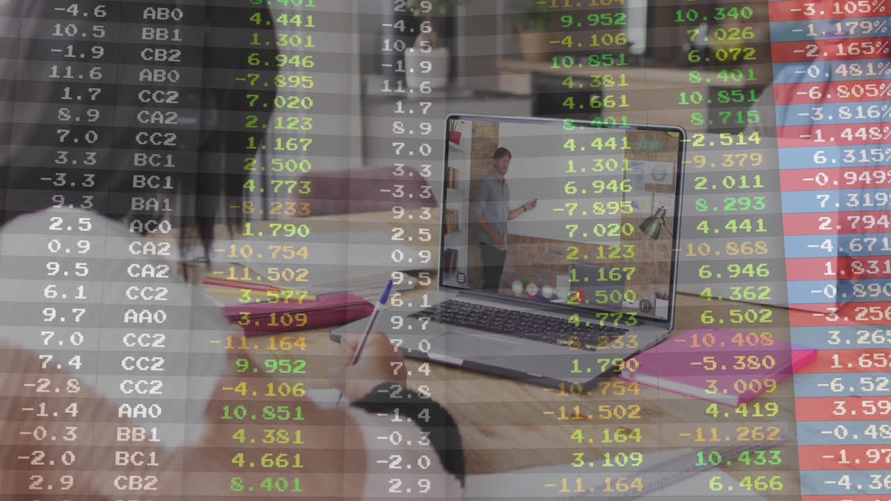 Financial animation overlaying people working on laptops in collaborative office