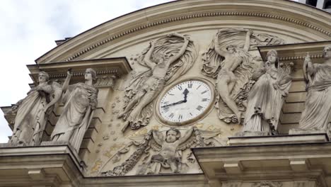 ornate building facade with sculptures and clock