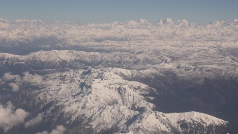 Scenic-aerial-flight-over-the-worlds-largest-mountains,-the-Himalayas-with-views-of-Mount-Everest-and-jagged-snowcapped-peaks