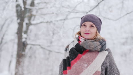 a young woman enjoys a walk in the snowy forest