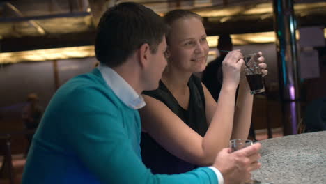 young couple relaxing in bar and having drinks