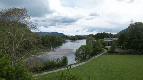 Aerial-video-over-a-calm-river-with-great-vegetation-on-a-cloudy-day-in-Lombardy-Calolziocorte-in-Italy