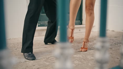 Legs-latino-couple-dancing-on-street-pavement-close-up.-Dancers-practicing-steps