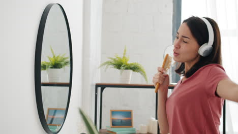 woman singing and brushing hair in bathroom