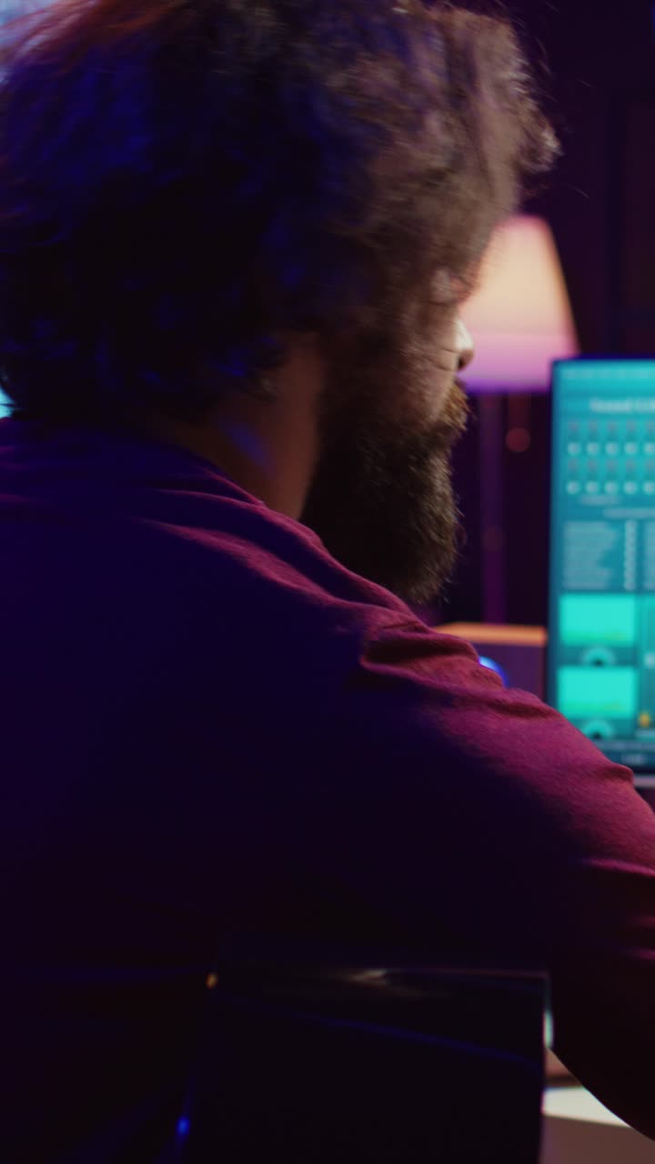 Bearded Man Playing Acoustic Guitar and Working in Music Studio