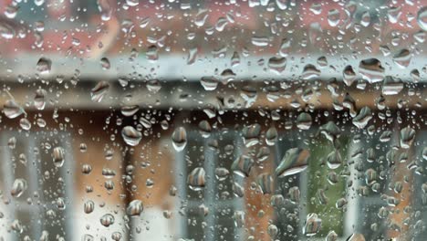 rain droplets on the window of a city apartment. a drop falling on the glass. rain and bad weather. depression and thoughts