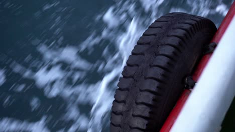 car tire on the side of the boat, while moving over the sea in istanbul