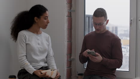 young couple takes a break during home renovation