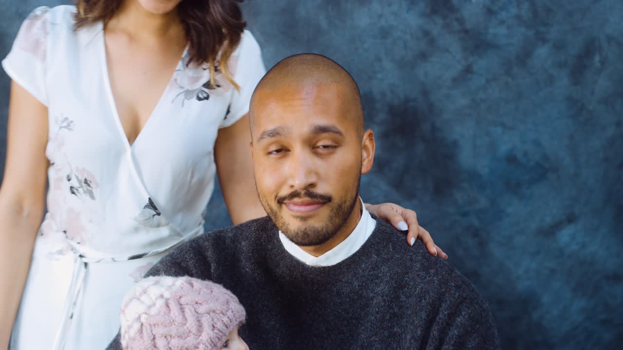 Family takes portrait with crying baby.