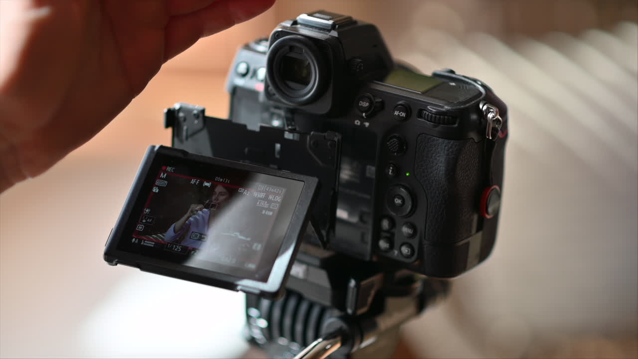 Camera filming a woman drinking a glass of red wine