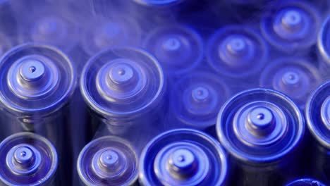 silver batteries aa and aaa in neon light close-up. double-a battery is a standard size single cell cylindrical dry battery. batteries are common in portable electronic devices. an aa battery is composed of a single electrochemical cell that may be either a primary battery or a rechargeable battery.