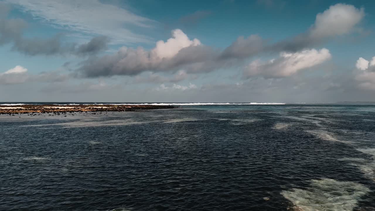 Revealing aerial view of clear, shallow sea water over a mixed sand and rocky seabed in Mauritius. Concept of ocean purity, water clarity, and pristine environment