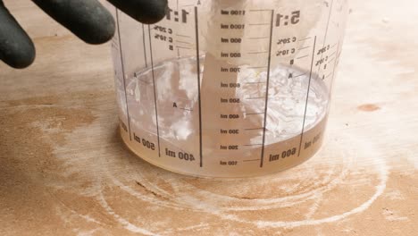 mixing polyester resin with catalyst in container