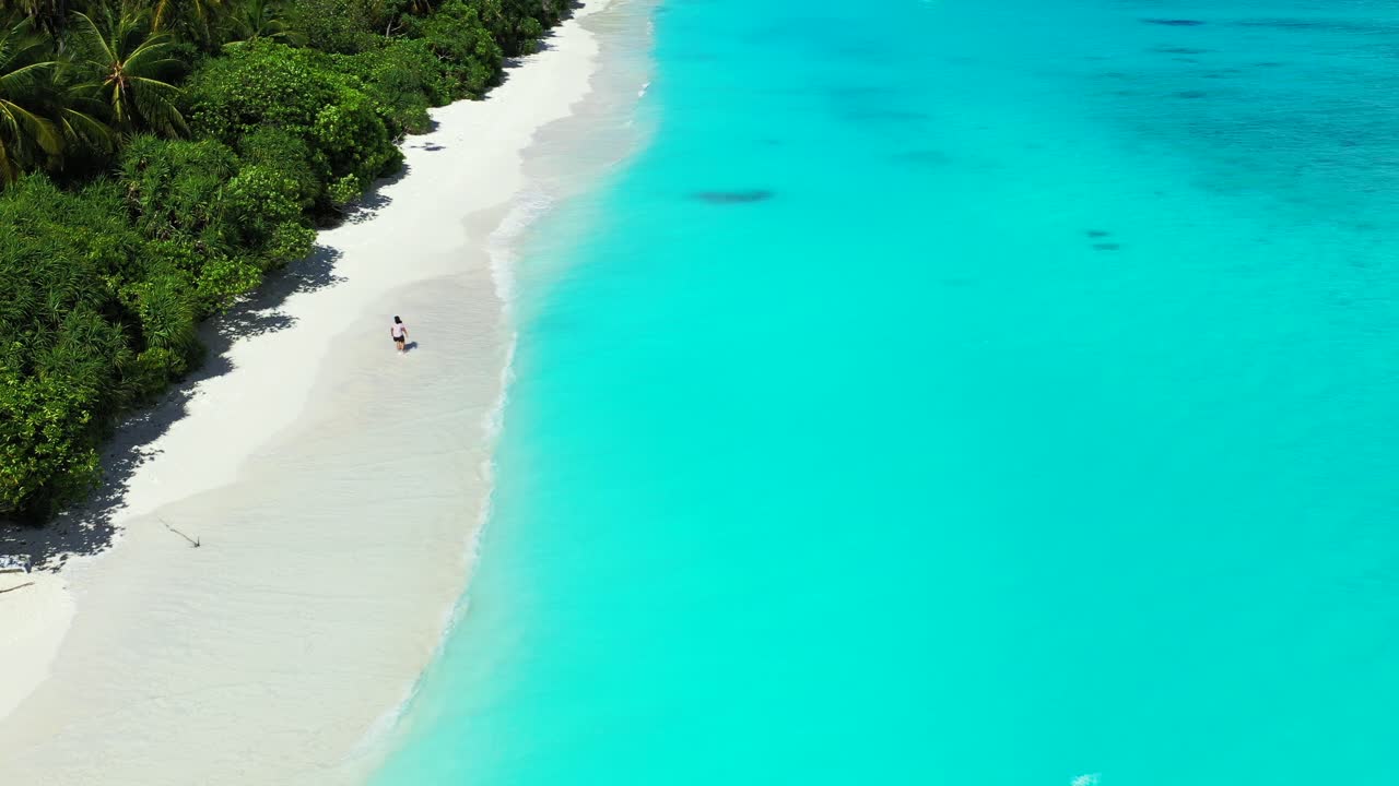 Young woman walking barefoot on the soft white sand, Maldives. Tropical luxury vacation concept