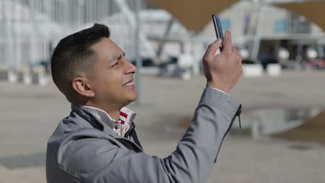 handsome young man recording video with smartphone