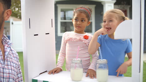 father buying lemonade from children's stall shot on r3d