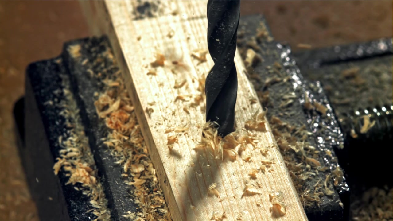 Close-Up of Drill Bit Drilling into Wood in Slow Motion