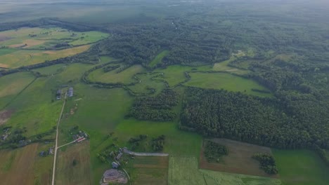 Country-side-panoramic-landscape-in-summer-time-from-above-and-ground-with-hay-rolls-and-roads