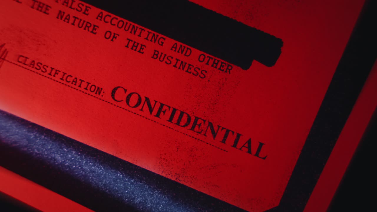 Close up on confidential government report in red light being scanned or copied. Scanner or copy machine close up. Censored text and classified information being compromised and sent in dark room