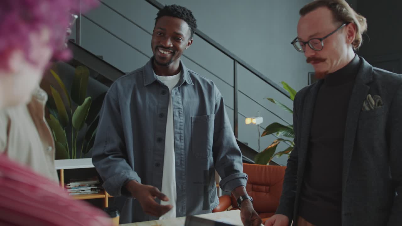 Black Man Discussing Project with Team of Colleagues at Meeting