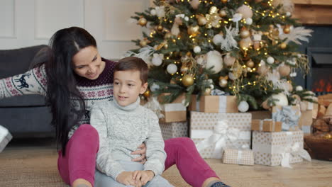 mother and son opening christmas gifts