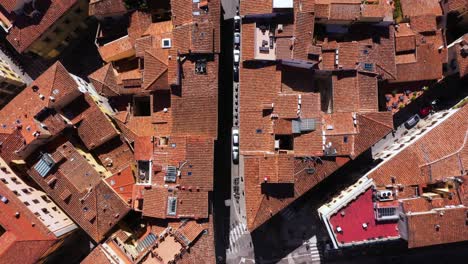 static top down view of roofs, roads and city on a sunny day in florence in italy in 4k