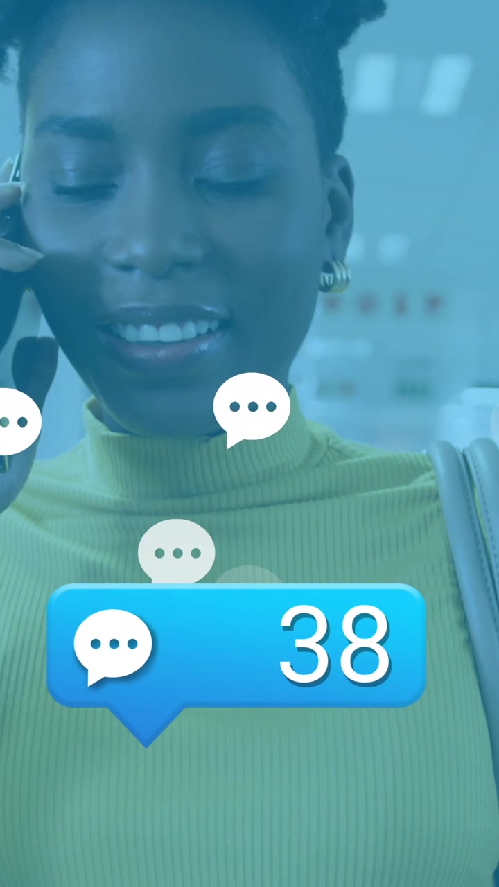 Animazione di reazioni sui social media sopra una donna afroamericana in ufficio che fa una chiamata