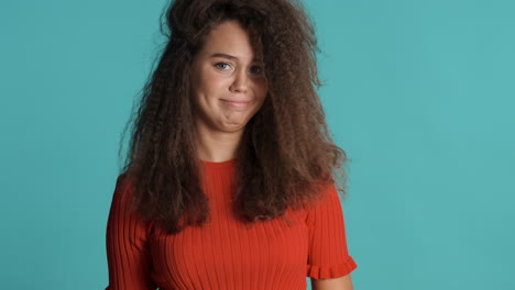 caucasian curly haired woman showing rejection in front of the camera.