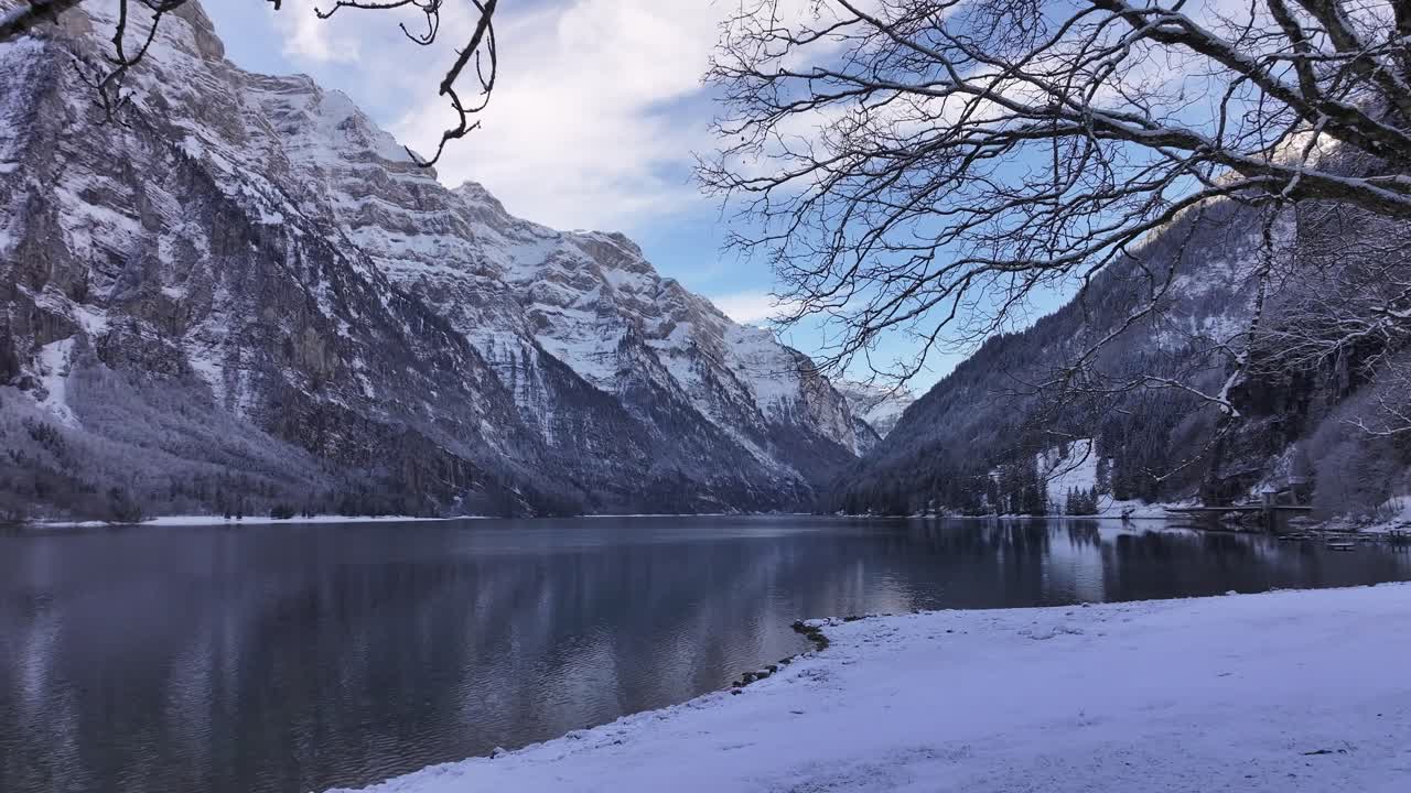 Snow covered Klöntalersee and mountains in Klöntal, Glarus, Switzerland