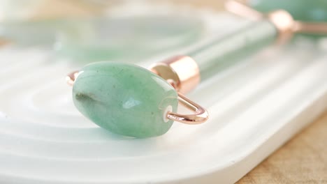 close-up of a green jade roller for skincare