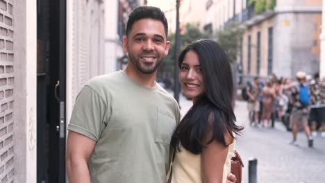 happy couple in standing together and posing in city during daytime