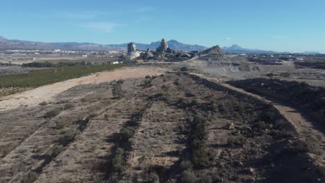 aerial revealing a large cement factory. dust in the air.