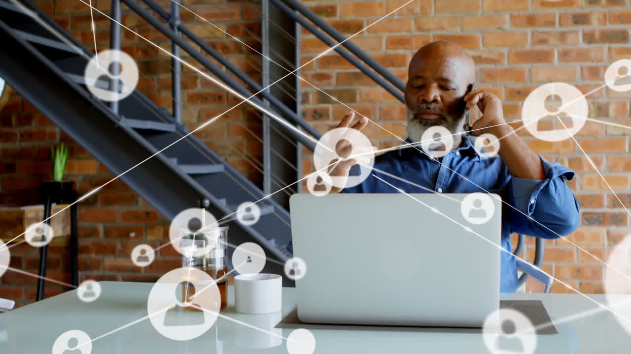 Animation of network of connections over african american businessman using smartphone and laptop