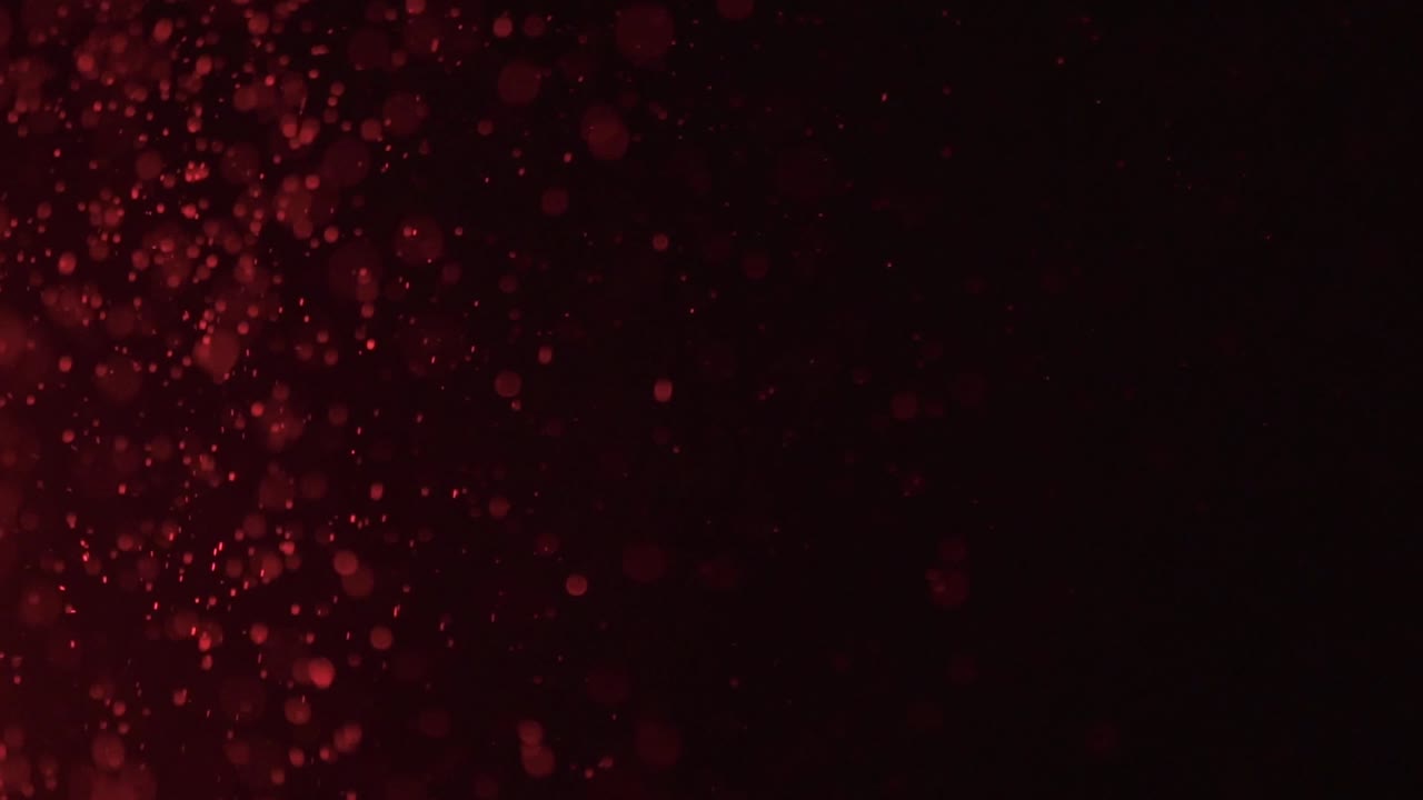 Red light shining on dust particles in the air.