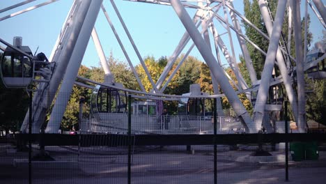 in the park, a large ferris wheel is spinning slowly. high-altitude view wheel