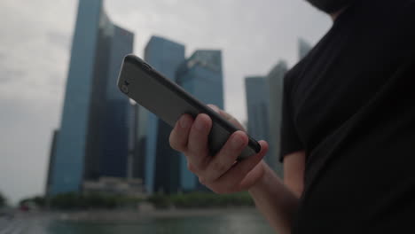 man using a smartphone in a city