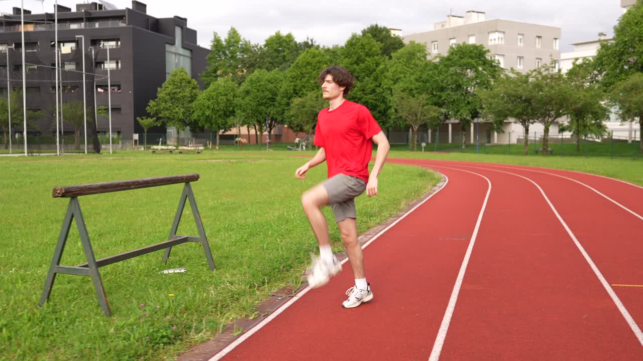 Man Stretching on Running Track