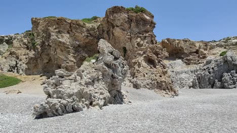 Passing-by-a-stony-beach-with-rocky-cliffs