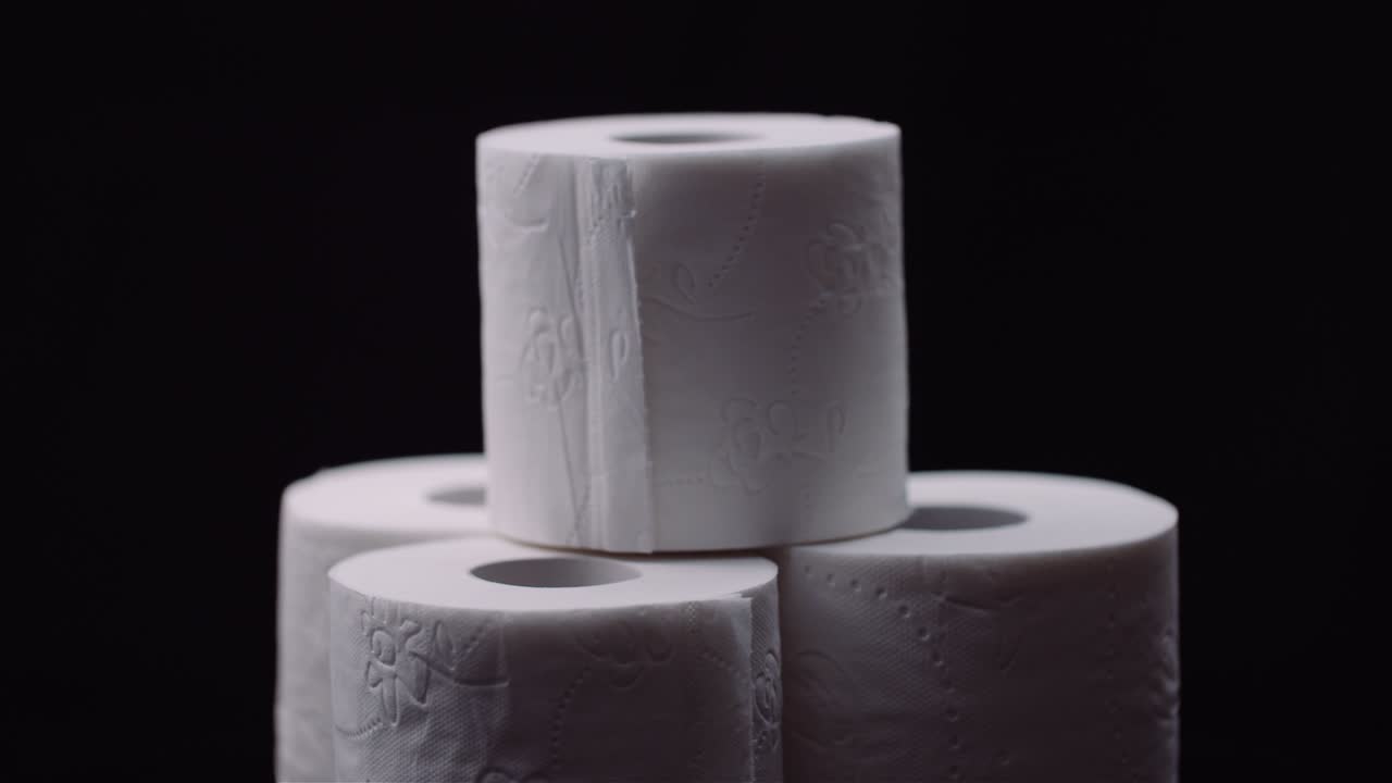 Toilet Paper Isolated on Black Background Rotating.