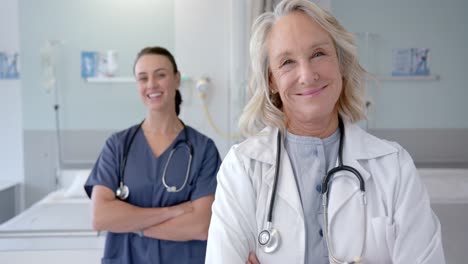 Portrait-of-happy-caucasian-female-doctors-in-hospital-room,-slow-motion