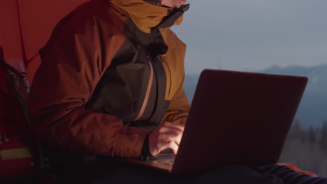 Female Tourist Working on Laptop in Camping Tent in Winter